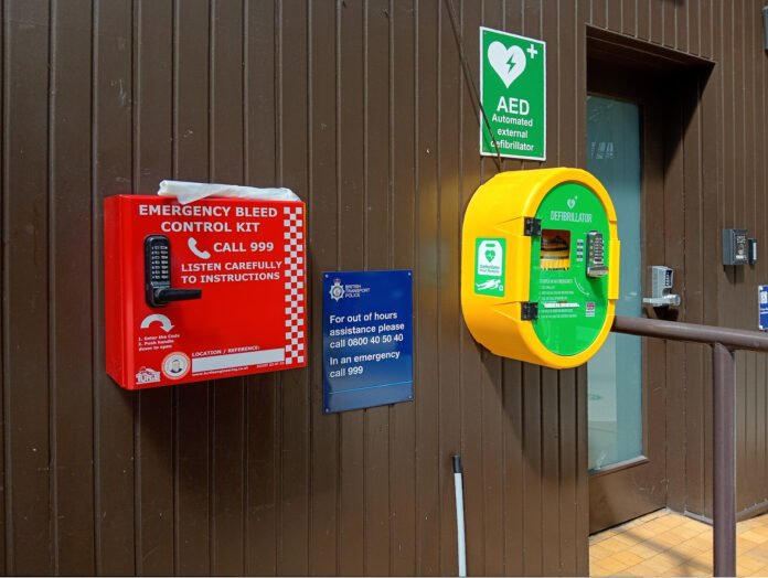 Emergency bleed control kit and defibrillator cabinet