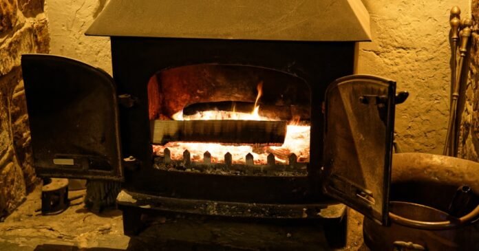 A wood-burning stove in a fireplace
