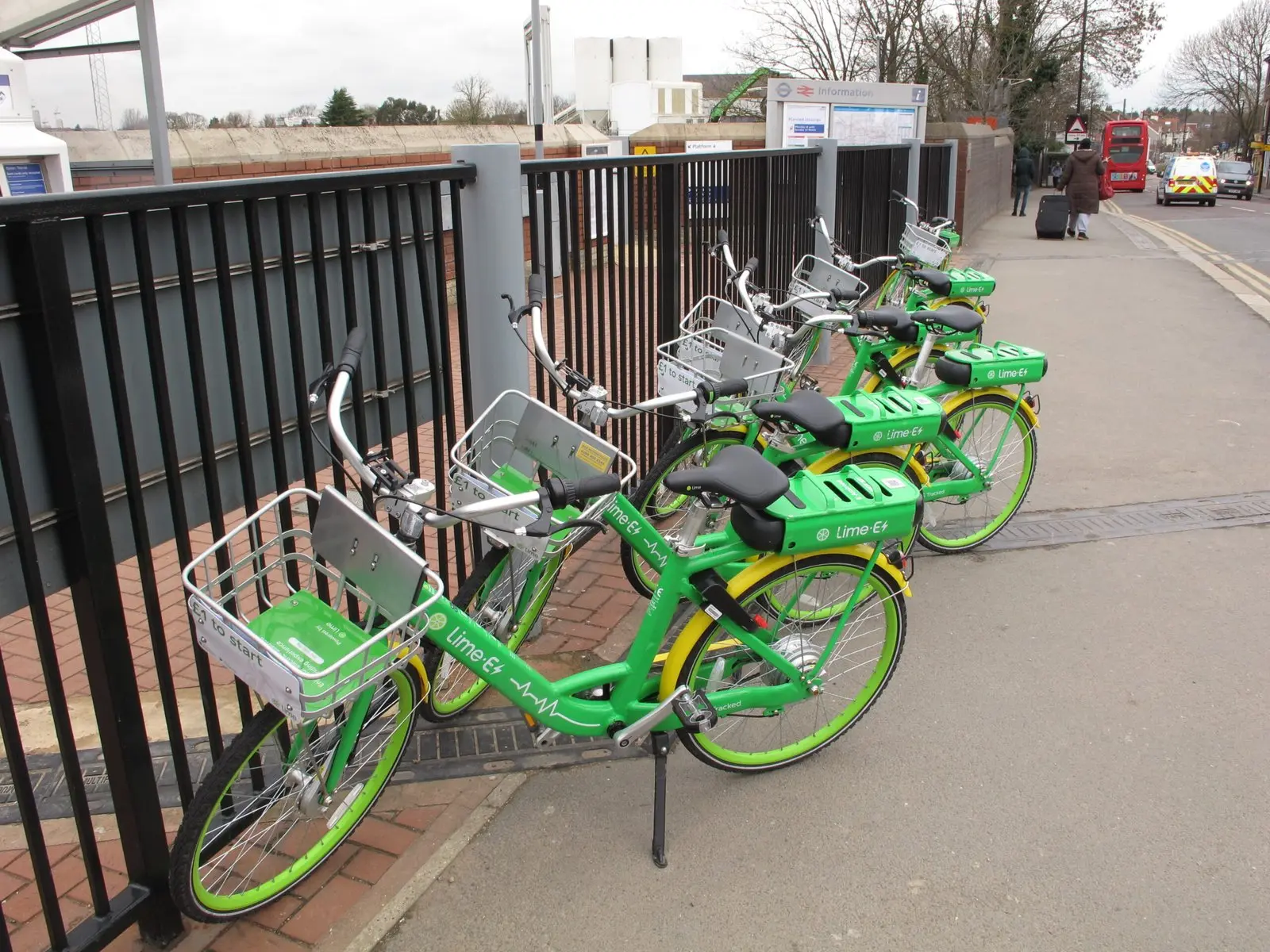 Dockless Lime e-bikes parked outside Acton Main Line station in London