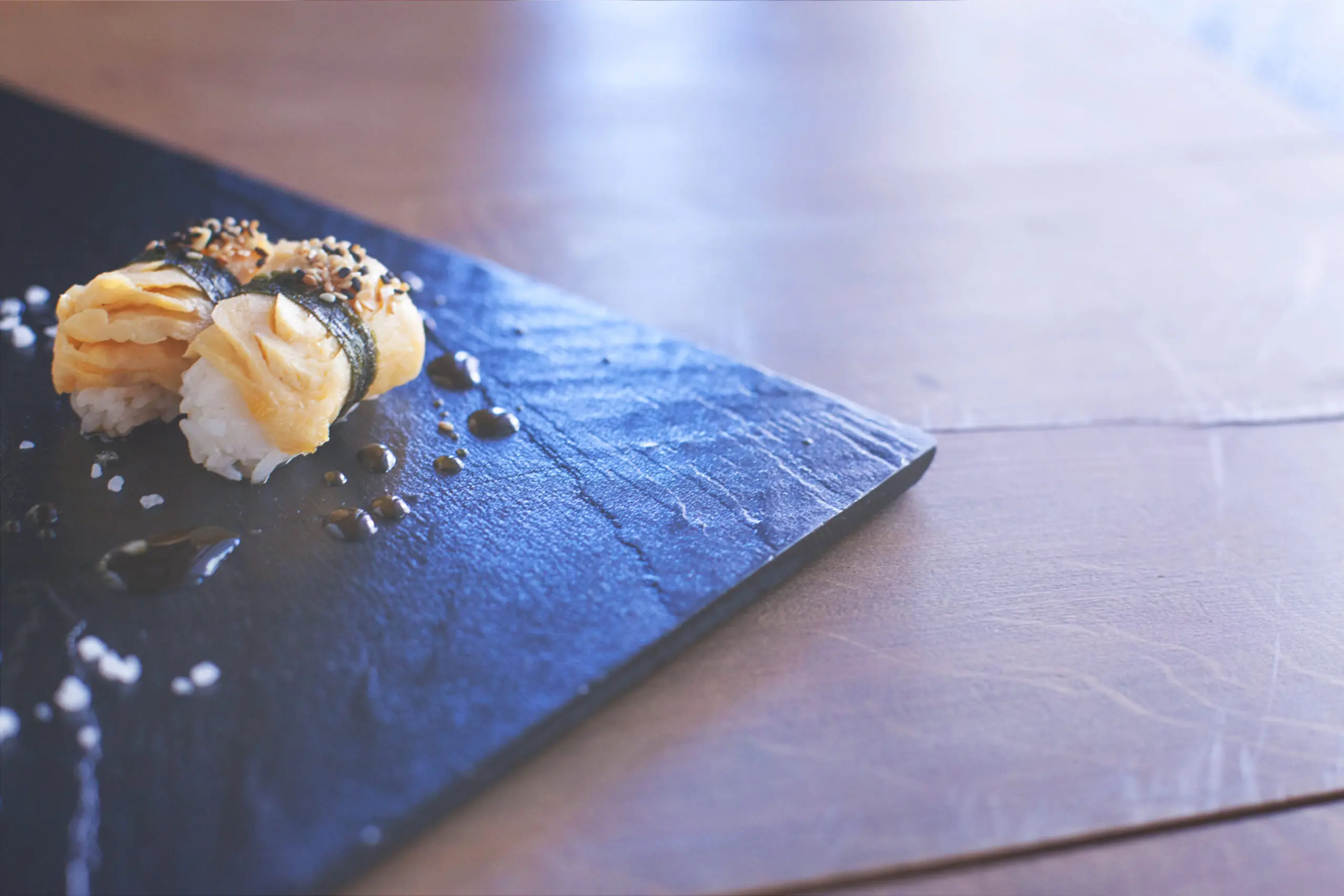 Salmon sushi rolls served on a stone plate