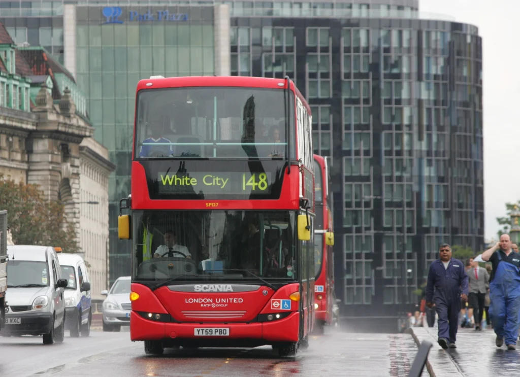 Red London bus on Westminster Bridge with the Houses of Parliament in the background