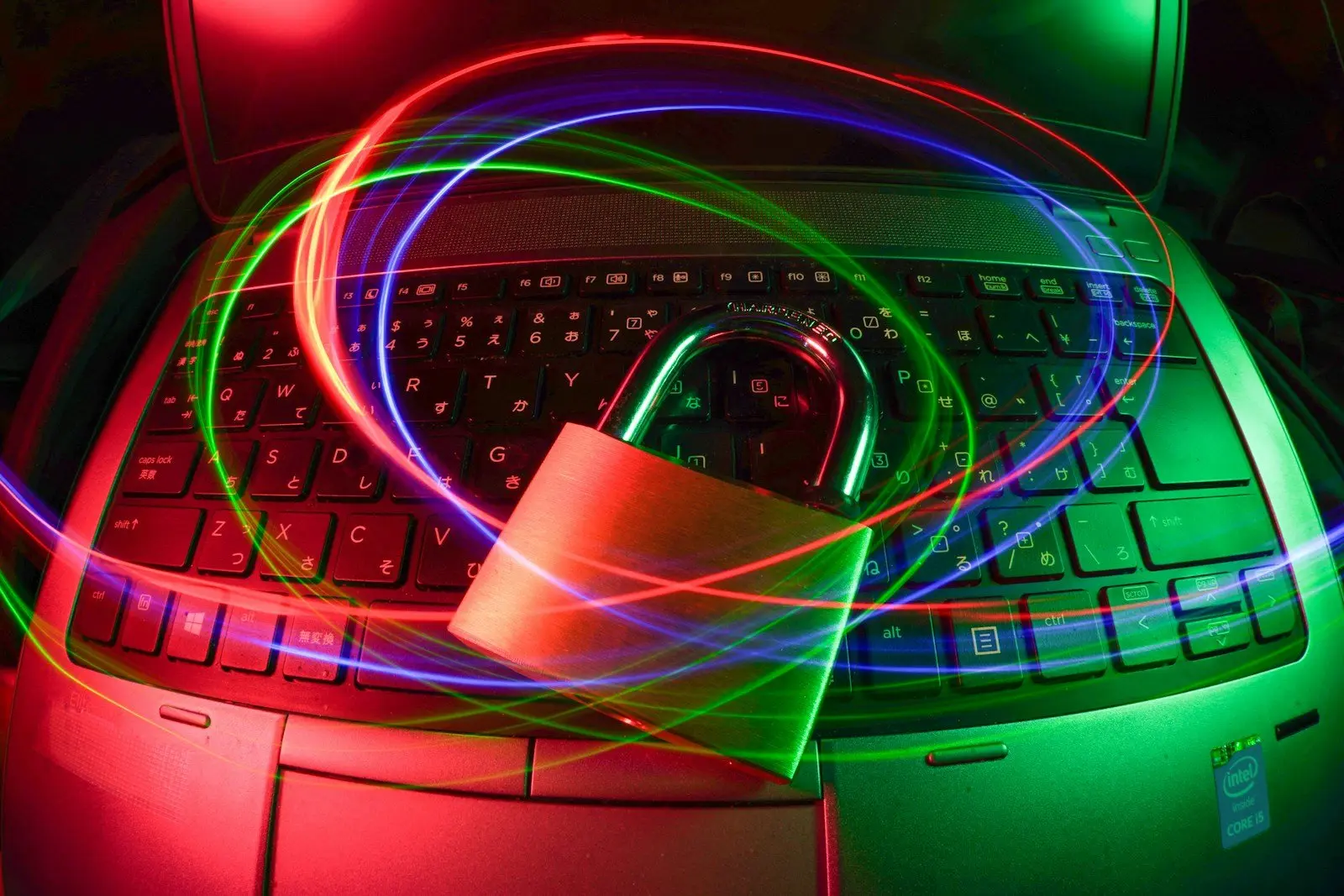 A padlock on a laptop with light trails, illustrating cybersecurity