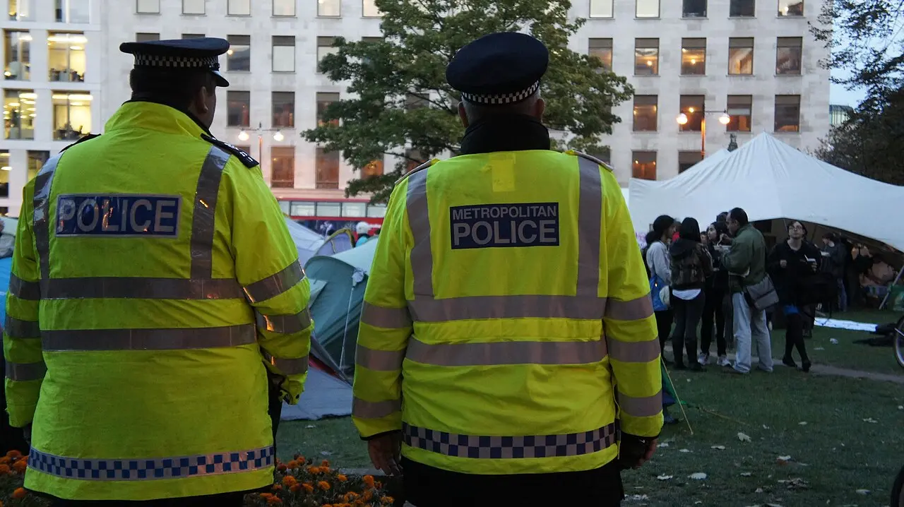 Two Metropolitan Police officers in high-visibility jackets in London