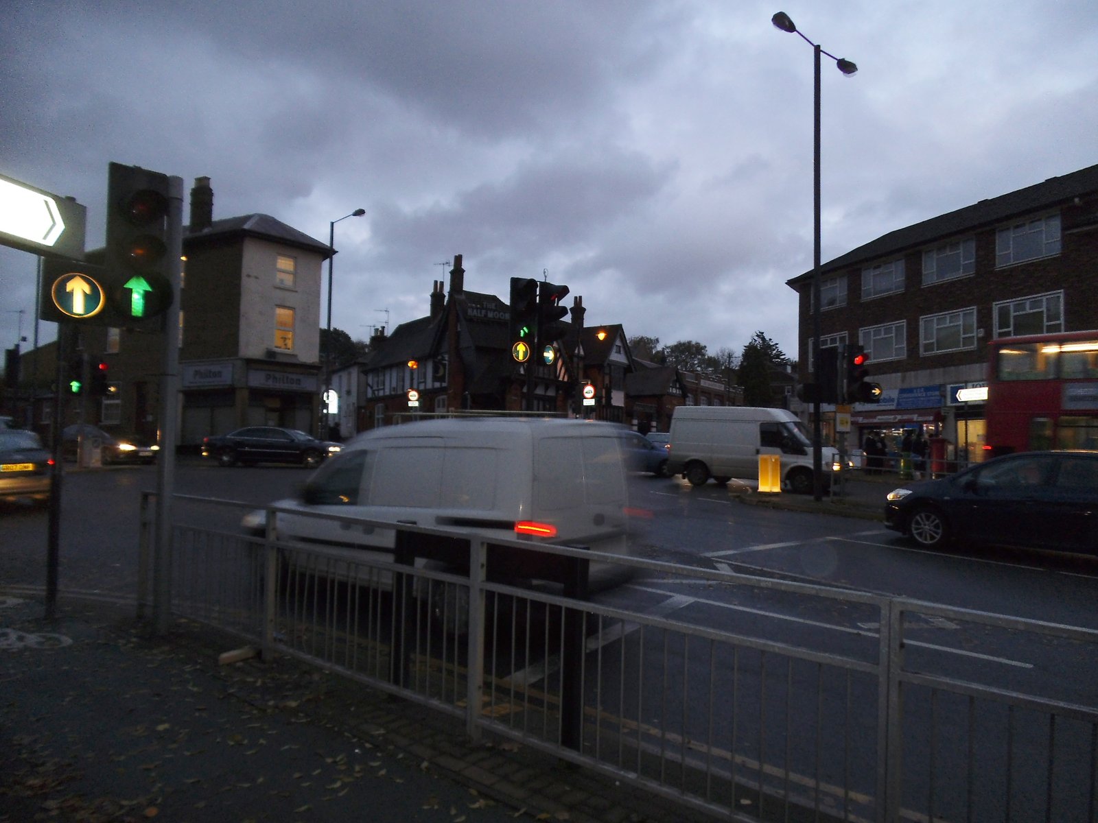General view of the junction of Northolt Road and Roxeth Hill in Harrow, with traffic lights, shops and vehicles